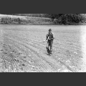 Man sowing oat seed with a  "horn" 