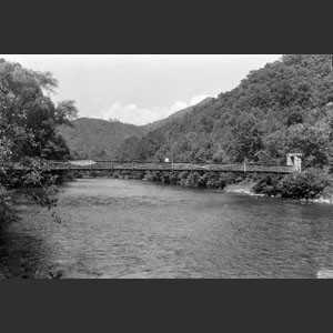 Swinging bridge over Oconolufty River Cherokee N.C. (Sis) on it