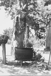 Princess in costume cooking over pot