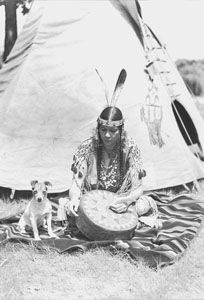 Princess with her dog Spotty painting tom-tom front of tepee