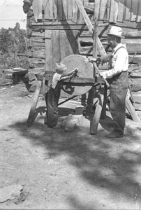 Man Sharpening axe at Smothermans - Good