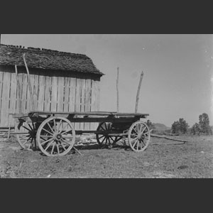 Wagon close-up barn in background