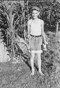 Wallace S_ 14 yrs old with the first fish he evere caught. Caught at Mrs. Clark's Mud Tavern Monday July 11, 1938. Cat-fish 6 inches, Perch 4 inches