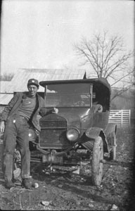 Gene J_ beside old T Model Ford at Aunt Betties