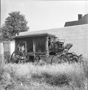 Old hearse behind funeral home out on Charlotte - Sunday